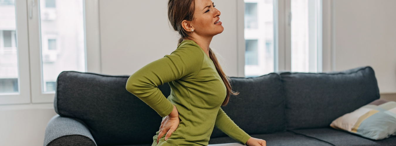 Woman with low back pain seeking relief treatment